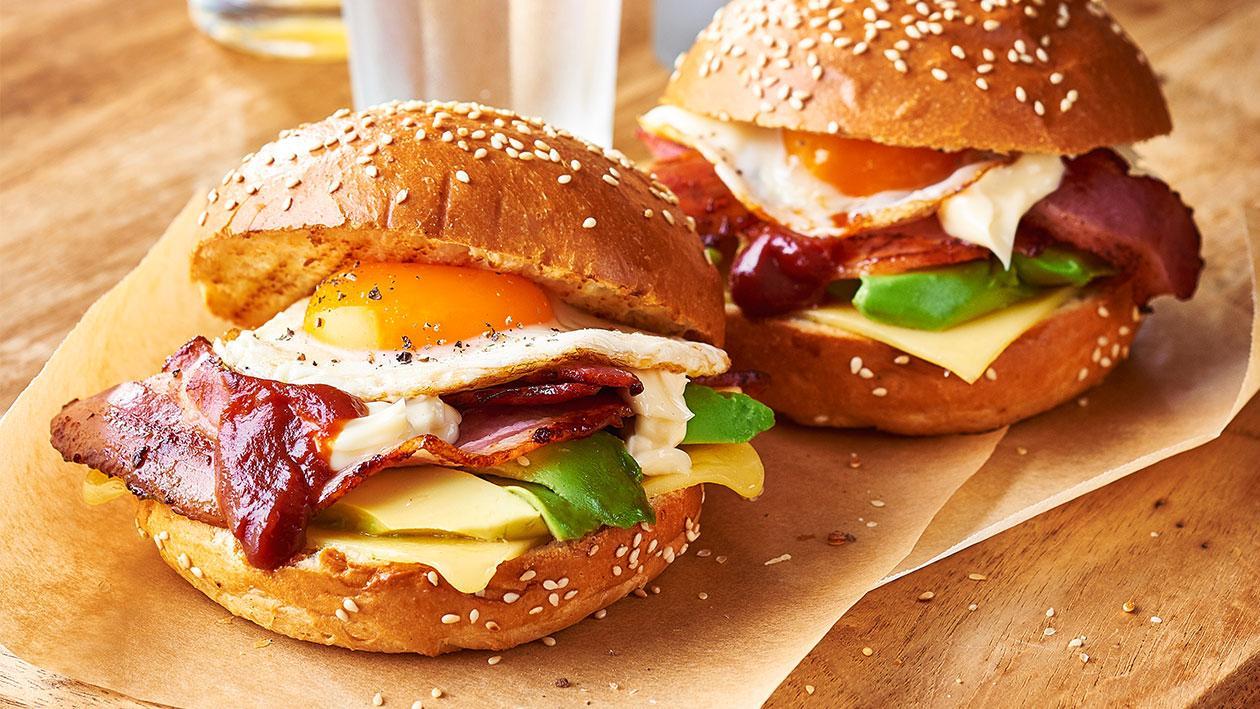 Bacon and egg roll with a runny yolk on baking paper