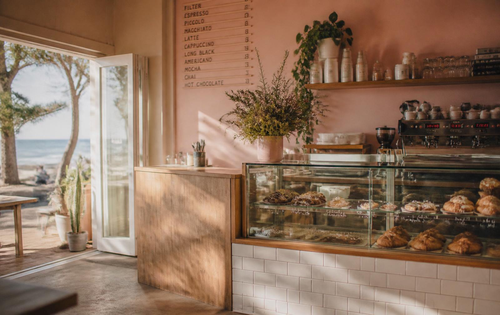 Warm interior of Rusti Fig cafe with the cake cabinet and espresso machine